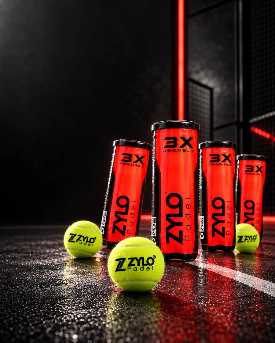 Four tubes of ZYLO Premium Padel Balls and three balls on a dark padel court lit in red