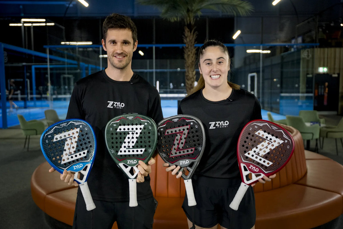 Josep Aymerich and Ainhoa Rico holding ZYLO KOREX rackets inside a padel club